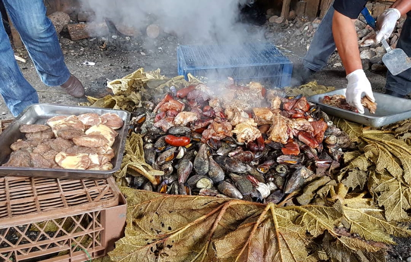 Curanto wrapped in leaves and buried in the ground in Chiloe